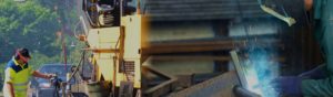 Worker operates construction equipment while other worker welds steel pipe behind workplace safety welding mask
